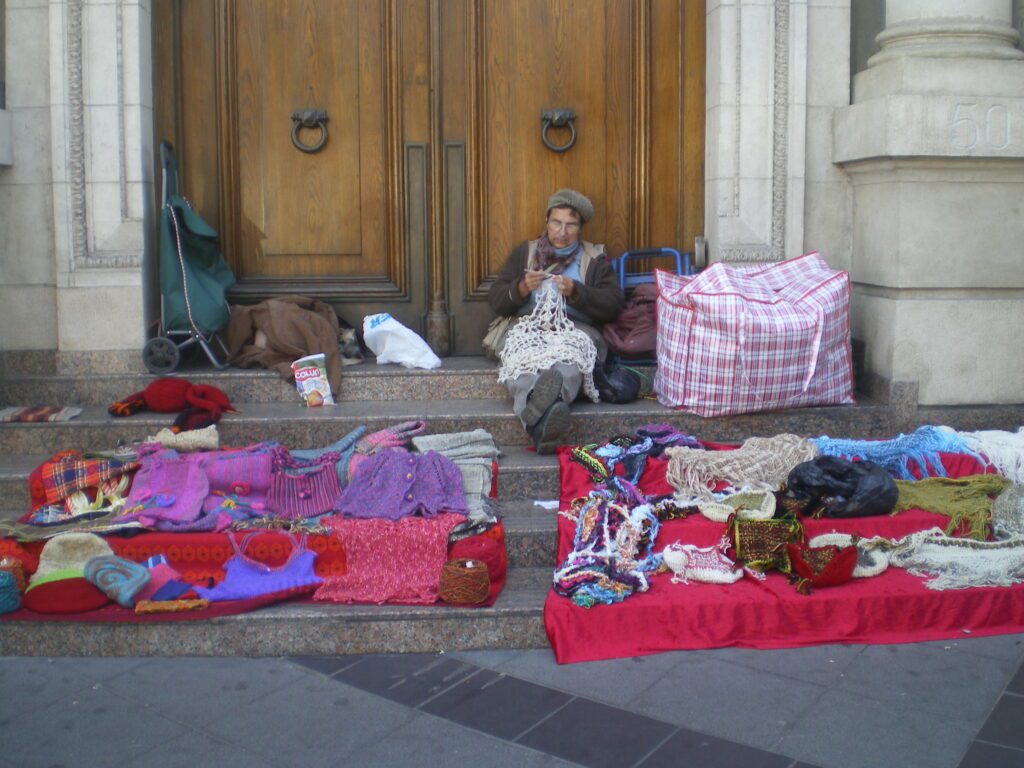 Parche, tejiendo en la Plaza Sotomayor, en Valparaíso, Chile